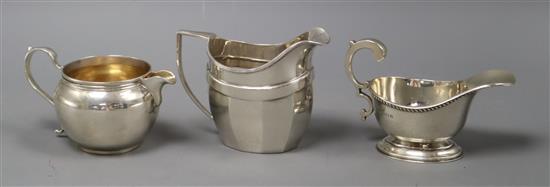 Three assorted George V silver cream jugs, 11 oz.